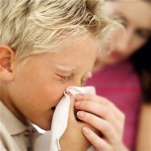 Boy sneezing with allergy problems.